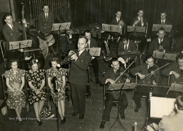"The Steelmakers accompany Tom Care, employee from the Steubenville Works, as he headlines with a trumpet solo. Tom played "At The End Of a Perfect Day", which appealed to a great number of Wheeling Steel's nation-wide family."