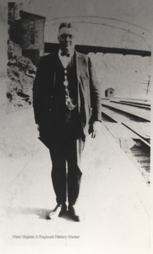 J. C. Lane pictured beside the railroad tracks. 