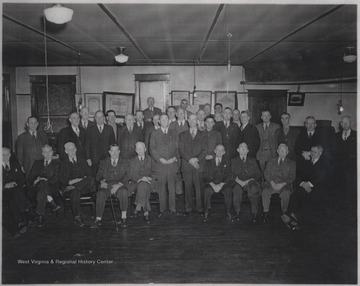 A group of unidentified men gather for a group photo in the building located on Third Avenue. 