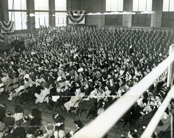 Picture taken during Wheeling Musical Steelmakers performance at WVU Field House, which was part of their "Buy a Bomber" series, where communities were challenged to buy enough Defense Bonds to purchase a bomber. The money raised in this circumstance exceeded all expectations and was the largest such fundraiser in Monongalia County, West Virginia.