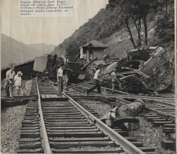 Johnny Richmond, pictured in the center with a cigarette in his mouth, and associates observe the wreckage which occurred around 5:00 p.m. 