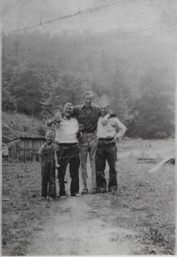Pictured from left to right is Donald Meador, his father Cecil Meador holding up a bottle, Oris Cook, and Pee Wee Woolridge.