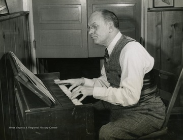 Caption accompanying photograph reads: "Man behind the "Musical Steelmakers" is J.L. Grimes, advertising manager of Wheeling Steel. He thought of the program in the first place, and is in active charge now, producing the show, choosing the music, and auditioning talent from the ranks of the employees and their families." It was a requirement to be an employee or immediate family member of Wheeling Steel Corporation in order to perform or work on the radio broadcast.