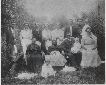 In the very front of the photo is Naomi Ruth Dennis, age 2. Seated from left to right is Walter T. Lilly, Mary E. "Molly" Lilly, Margarette Louise Whitten Lilly, and James L. Lilly holding Aubrey C. Lilly, age one.Standing in the back is Emberry S. Taylor, Verlie Lilly Taylor, Clarence W. Dennis, Josie Lilly Dennis, Margaret E. Lilly, Charles Edgar Pitzer, and Nelly Lilly Pitzer holding Margaret Pitzer, age 2. 