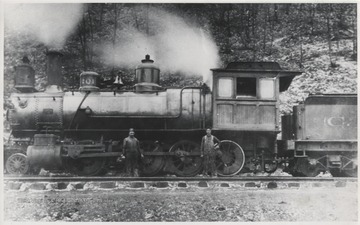 Two unidentified railroad employees stand beside Engine No. 201 on the C. & O. Railway.