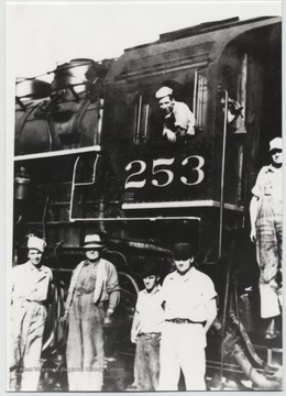 Pictured from left to right is J. E. Burdette (brakeman), O. C. "Battle Ax" Allen (conductor), Hobart Akers (brakeman), and Jack Sweeney (brakeman) with N. B. Allen (engineer) on the steps and C. L. Keaton (fireman) in the cab.