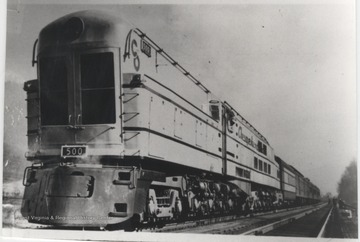 Photo of the first coal-burning, steam, turbine, electric engine--the largest single unit locomotive in the world. As long as 154 feet and 9 3/4 inches, including the water tender. The top speed was 100 miles per hour. The engine weight 411.5 tons.  