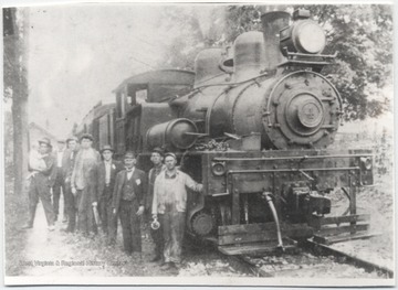 From left to right is Harry Lee (holding his daught, Lucy), Lum Bennett, Emmitt Crotty, Cap. Starrett Moore, John Dobbins, John Wilt, Mark Perkins, and Mitchell Dilly.