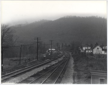 View of the tracks which split the town. Buildings and homes are pictured on either side.