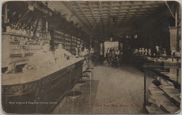 Postcard published by Tom Jones of Cincinnatti, Ohio. Three unidentified men stand behind the counter on the left while a group of men sit at a table in the background.