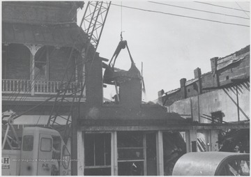View of the broken building following a fire. The three-story, brick building was originally erected to house Rose's Drug Store, Co.