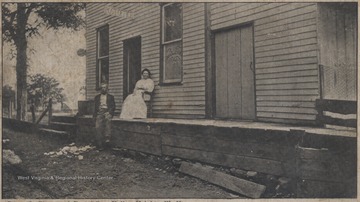 An unidentified man and woman sit outside the building.Published by Nonpareil Ptg. & Pub. Co.