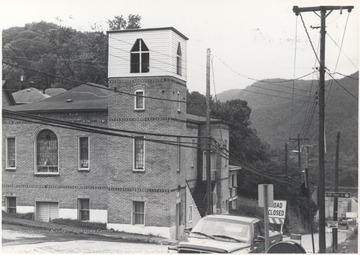 An unidentified church is pictured. In the background, a sign for Elk Knob Road is posted on a light post. 