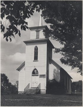 View of the building's entrance. The church steeple extends high into the sky.