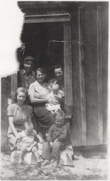 Mrs. Maude Wiseman Adkins in center with Depsey Adkins to the right and Gladys Richmond Adkins to the left. Dalena Boone is left of Badie Bracken Adkins, who is the girl in the front, and left of her is Joyce Delano. Nile Boone is the boy sitting in the front.