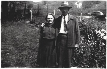 Eva Reed, left, and Cornelius "Neil" Louis Burdette pictured beside a garden.