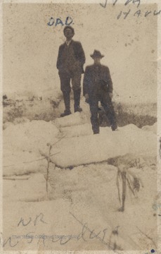 Jim Harvey, right, and man labeled as "Dad", left, are pictured on top of the ice between Crump's Bottom and Forest Hill District. The ice, sawed and removed, was stored in a sawdust shed and would last into the summer. 