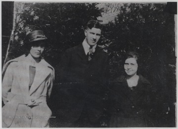 Noel, pictured in the center, is pictured with two unidentified women. 