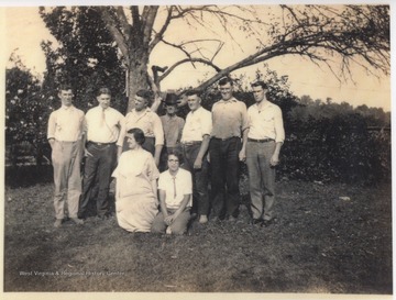 From left to right is Maudie Noel (kneeling); Minnie Noel (kneeling); Harvey Noel; Clyde Noel; Emmitt Noel; Henry A. Noel Senior; Bob Noel; Clarence Noel; and Lawrence Noel. 