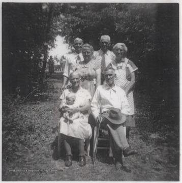 Pictured in the first row is Sally Margaret King; Cook Pettry (seated); and Lou Pettry (seated).  Second row pictured is Francis Meador and Josie Farley. In the back row is Crockett Farley and Ben Goff. The group is pictured on the Lou Pettry Farm. 