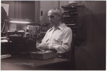 Sieber sits behind a desk at the telegraph office.