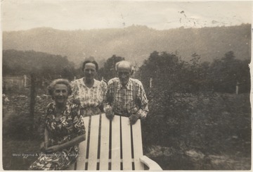 The elderly group poses beside a lawn chair in a field located at New River Bottoms, the future sit of the Bluestone Reservoir.