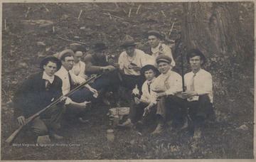 Male members of J. D. Morris family gather around to play cards.