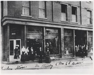 William Plumley pictured with female associates outside of the store entrance. The building later housed Hinton Furniture, owned by Ray Walker. 