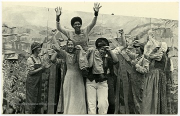 The caption on the postcard reads: "The moment of John Henry's victory, seconds before he dies. Performance of "John Henry" by EcoTheatre, the indigenous summer theater company of Summers County young people. Kathy Jackson in the title role.""John Henry" was a successful EcoTheater play that was performed often.Maryat Lee (born Mary Attaway Lee; May 26, 1923 – September 18, 1989) was an American playwright and theatre director who made important contributions to post-World War II avant-garde theatre.  She pioneered street theatre in Harlem, and later founded EcoTheater in West Virginia, a community based theater project.Early in her career, Lee wrote and produced plays in New York City, including the street play “DOPE!”  While in New York she also formed the Soul and Latin Theater (SALT), and wrote plays centered around the lives of the actors in the group.In 1970 Lee moved to West Virginia and formed the community theater group EcoTheater in 1975.  Beginning with local teenagers from the Governor’s Summer Youth Program, the rural theater group grew, and produced plays based on oral histories collected from the local community.  Each performance of an EcoTheater play involved audience participation and discussion.  With the assistance of the Humanities Foundation of West Virginia, guest scholars became a part of EcoTheater.