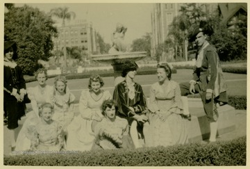 Back row from left to right: Tom Clark, Julia Swiger, Lois Morrissette, Julia Young, Bill James, Mary Alice James, Merlin Arms.  Seated in front from left to right: Eleanor Jean James and Aladyne Wymer.Established in 1938, the Madrigal Singers of Clarksburg have been performing for more than 75 years.  During the 1940's through the 1970's, Bill James directed the group. E.W. "Bill" James wrote "My Home Among the Hills" for the West Virginia Centennial among other musical compositions.  The madrigal group performs some recent music, but primarily sings music dating from the English Renaissance while wearing period clothing.