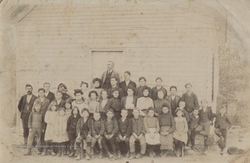 Keadle, standing in the far back, poses with his classmates. Keadle was a locally known instructor during the turn of the century in the Forest Hill District.