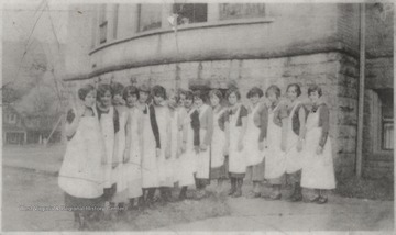 Mrs. Nell Graham's home ec class pictured outside of Hinton High School. Subjects unidentified.