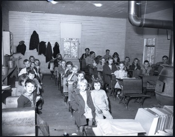 School children sit behind their desks. Subjects unidentified. 