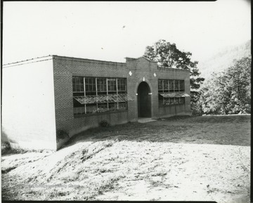 Side view of the school entrance, where the windows are partially open. 