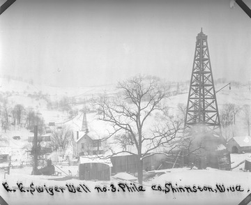 Shinnston oil well and field covered in snow.