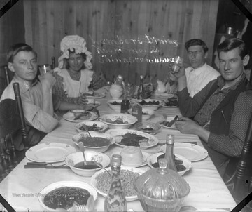 A group of people sit at a table for dinner.