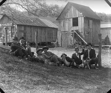 Group of unidentified men and two dogs are in front of Lambert Store and Restaurant in Adamsville, Shinnston, W. Va.