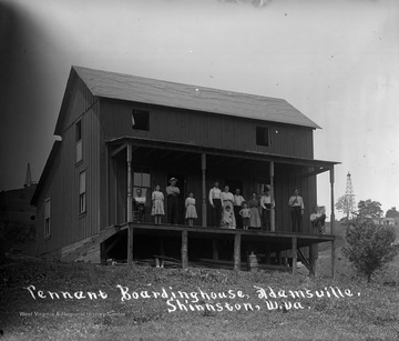 Unidentified group of people on porch of boarding house.