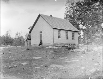 Jones is pictured on the steps of a school house. 