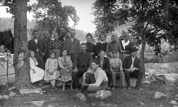 The family is pictured posing for the portrait between two trees likely in W. Va. Subjects are unidentified. 