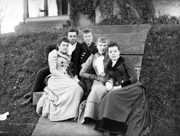 Group of unidentified people, likely West Virginia University students, pose for a portrait on steps.