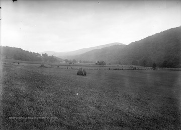 View of a farmer's field and a farm house.