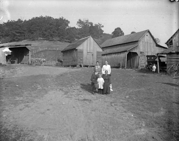An unidentified family is pictured outside of their rural home.
