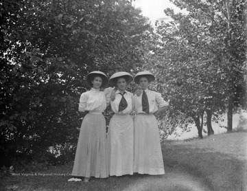 Three female students stand for a portrait at West Virginia University, Morgantown, W. Va.