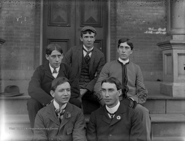 Five male students sit on the steps in front of a building at West Virginia University, Morgantown, W. Va.