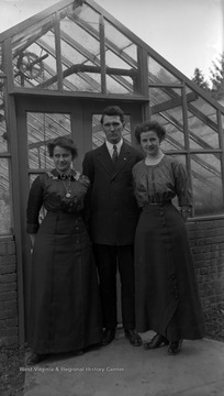 A.J. Dadisman (center), Nail, and Allender pose in front of WVU green houses.