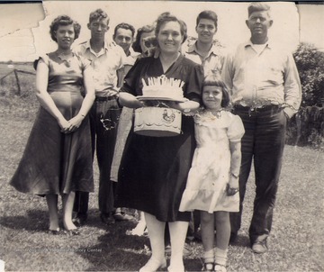 Front Row: Pauline Barr Sirk and Daughter, Mary; Back Row, left to right: Juanita Sirk Stevens, Arnold Stevens, Unidentified man, Unidentified woman, Jim Sirk, and James Bernie Sirk.