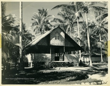 Marshall L. Williamson and the 57th Naval Construction Battalion's chapel on the island of Espiritu Santo, within the New Hebrides.On the back of the photograph there is this note: "This is our chapel which is located in our camp."