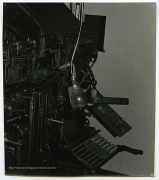 A linotype machine involved in the newspaper operation at the Wirt County Journal in Elizabeth, W. Va. owned by Woodrow "Woody" Wilson.The photos in this collection were used in chapters that appeared in Mountain Trace, a publication of Parkersburg High School in West Virginia, edited by Kenneth G. Gilbert.