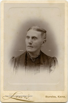 Portrait of Sarah Murray Woodcock, likely a resident of Keyser, W. Va., taken in Eureka, Kansas from a photograph album of late nineteenth century images featuring residents from Keyser, W. Va.  Written on the back of the image are the words "For Aunt Jane."
